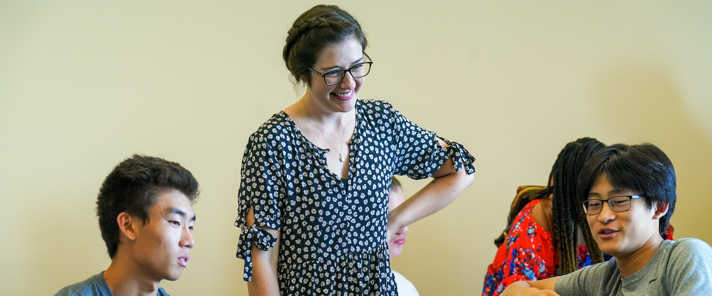 Davis helps two students on computers