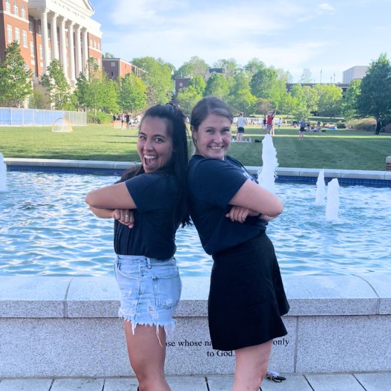 Alexia Scott and friend post in front of the Belmont fountain