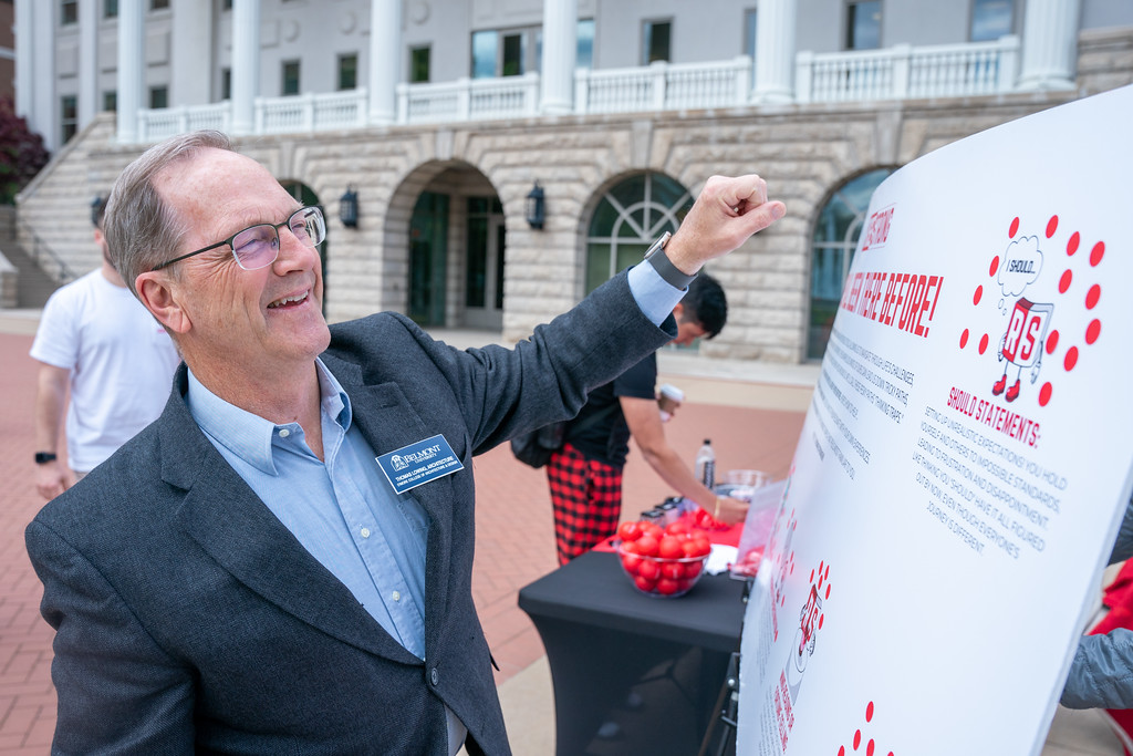 staff member looks at a pop-up event poster