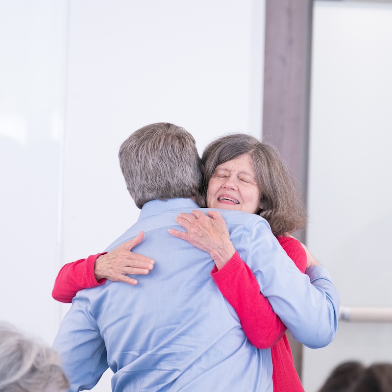 Two professors hugging at the Teaching Center 30th anniversary luncheon