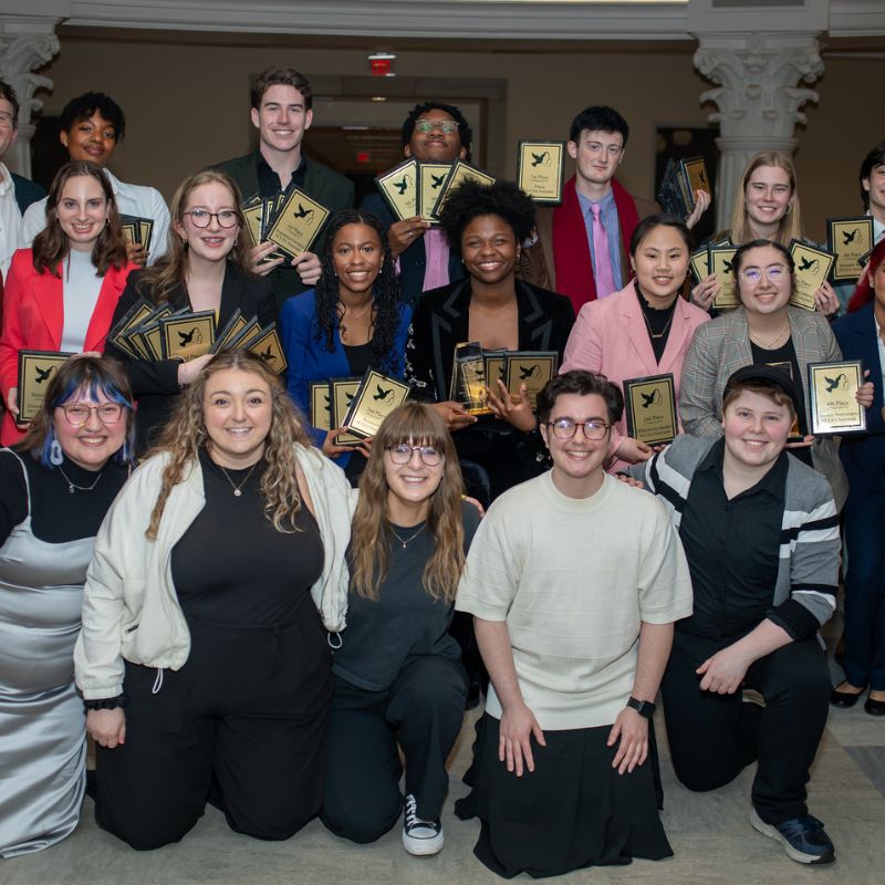 Belmont's Speech and Debate team poses with their trophies