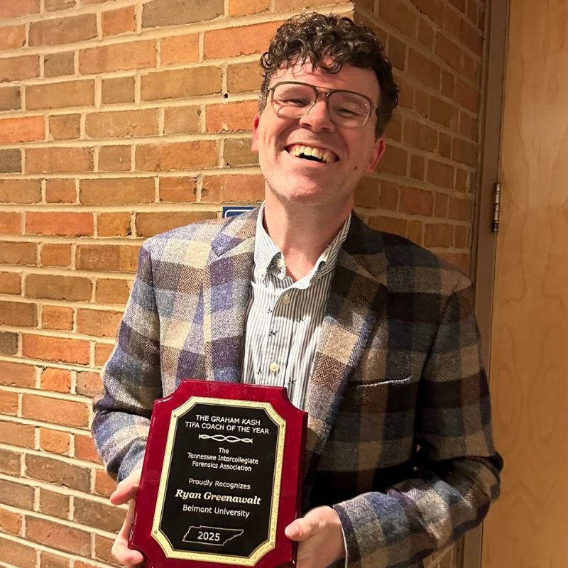 Ryan Greenawalt holding the Graham Kash TIFA Coach of the Year Award