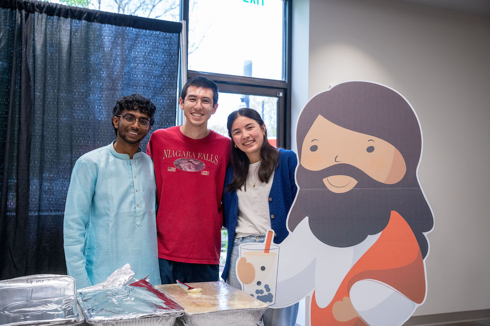 Student take picture with Boba Jesus cutout