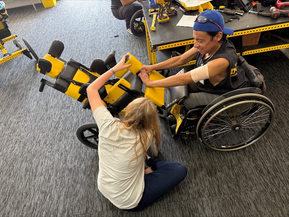 Student assists local with a wheelchair 