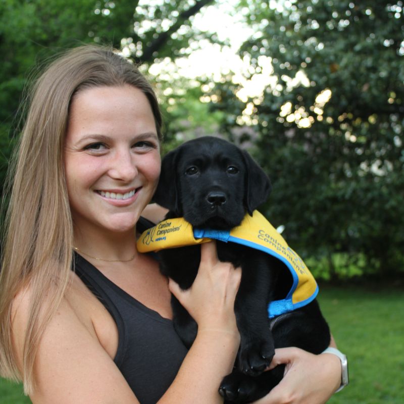 PT student Morgen Wilkes holds Paddy the service puppy
