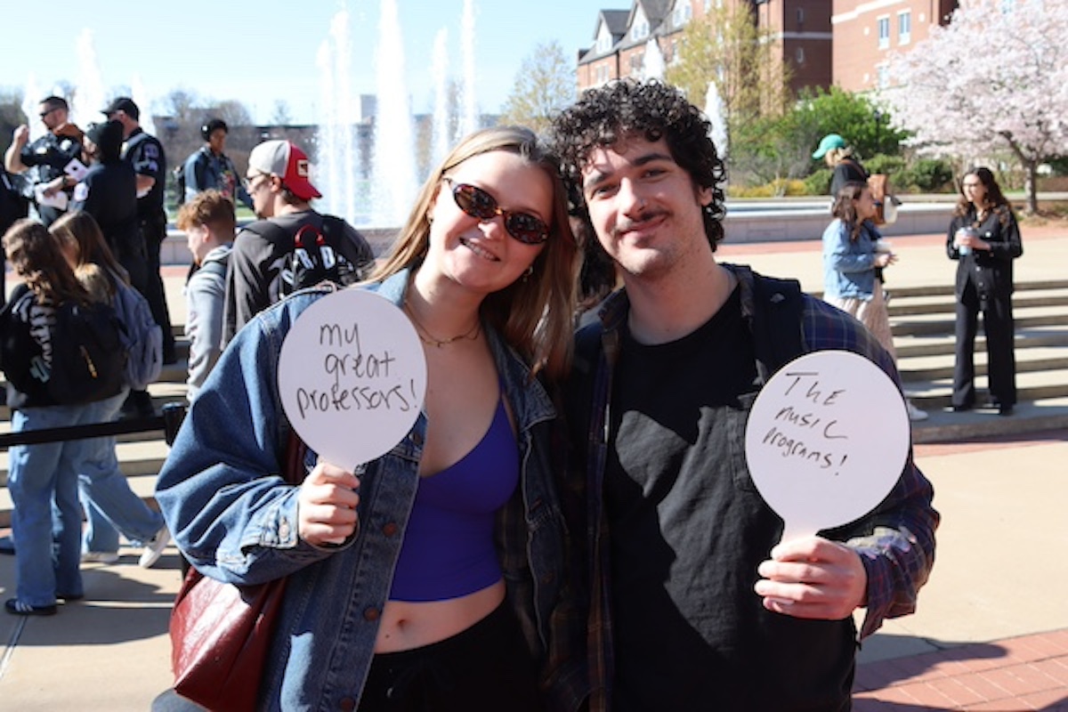 two students with handheld whiteboards