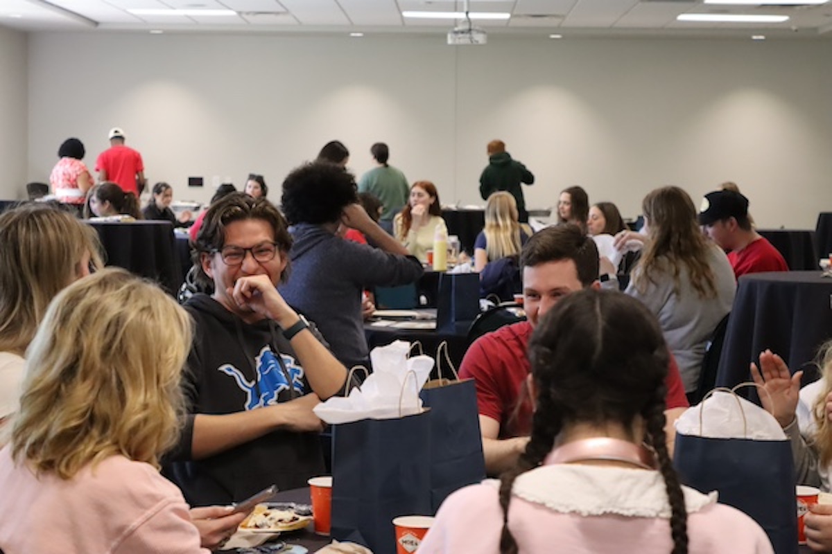 students laughing while sitting at a table
