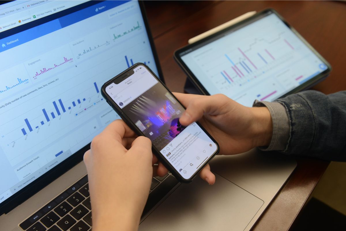 phone in front of computer displaying social media analytics