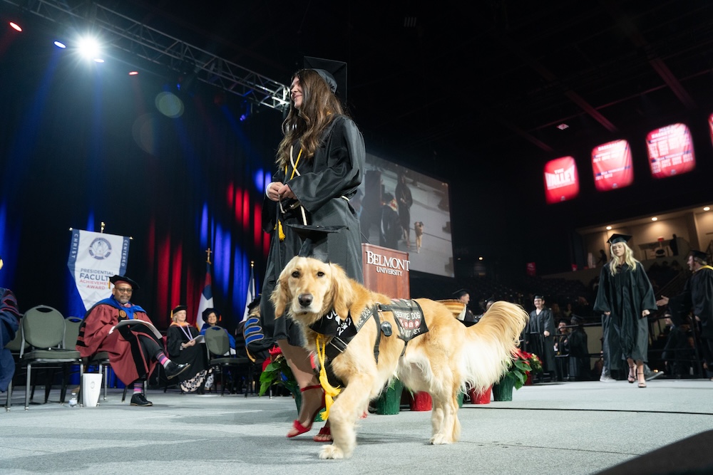 a dog crosses stage at graduation