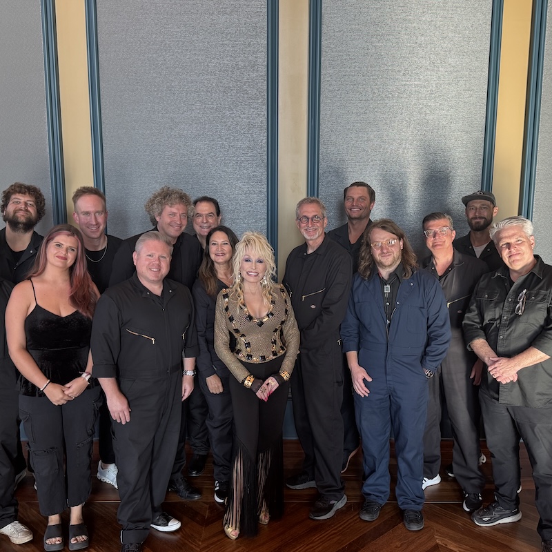 orchestra members pose with Dolly Parton