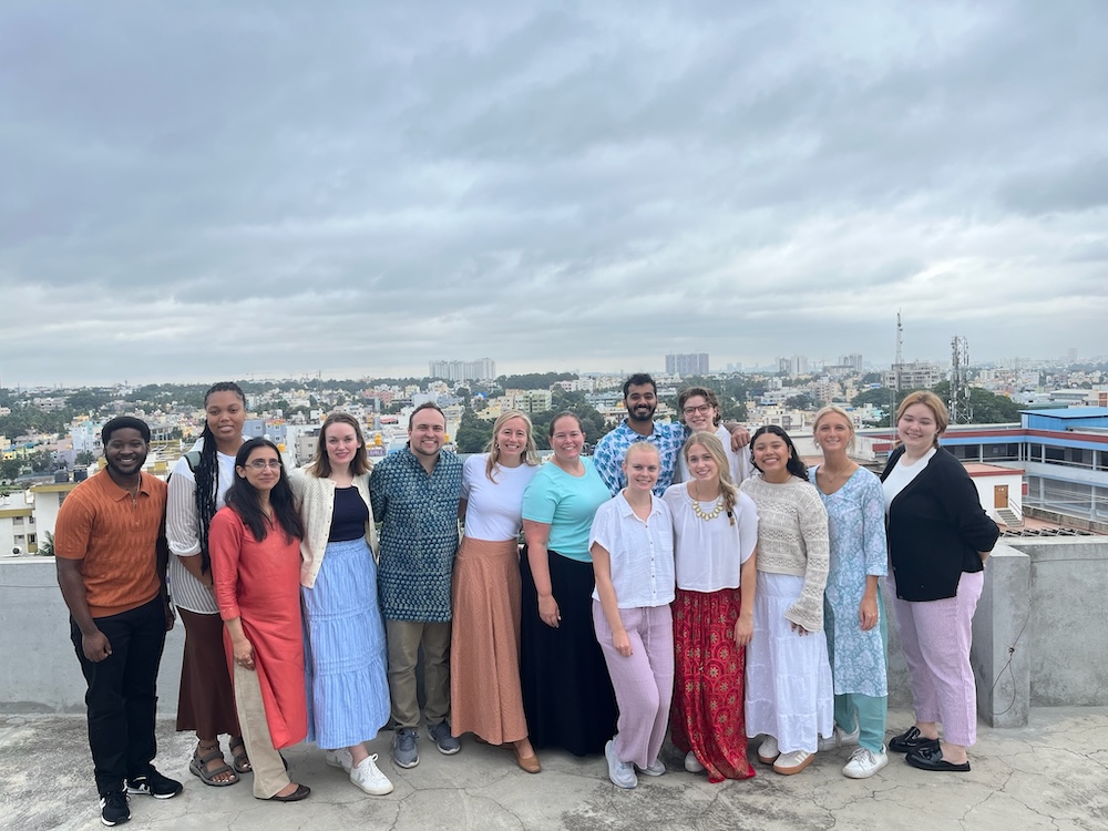 Cohort poses in front of city