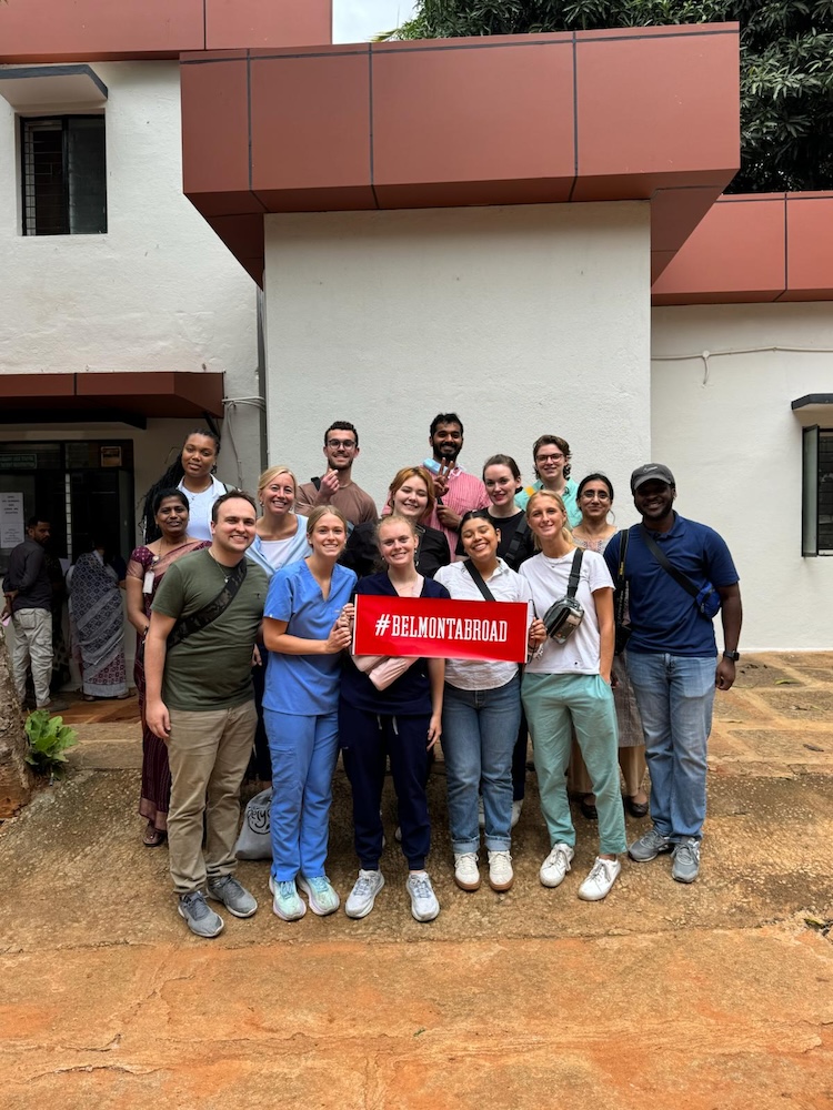Students pose with Belmont Abroad sign