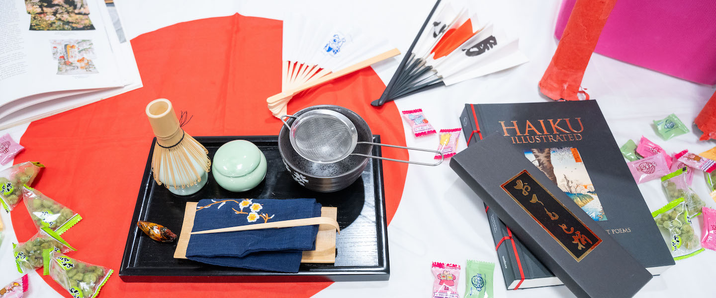 Table with tea set, haiku book and candies