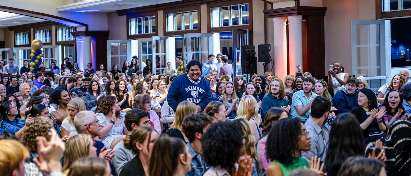 Student standing among crowd of peers