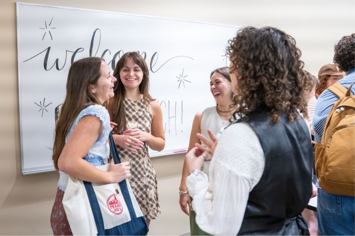 People talk and laugh at the 2025 Belmont Literary Journal launch party 