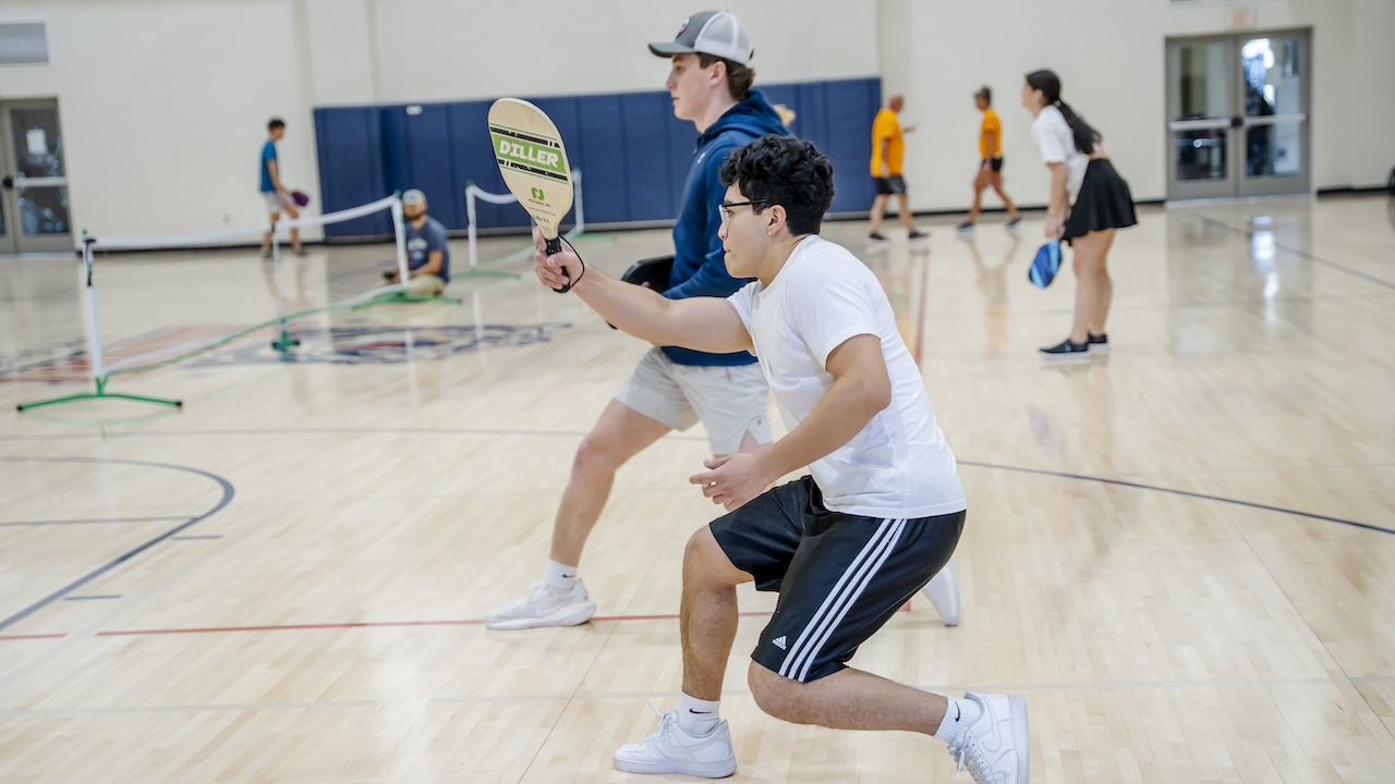 two students playing pickleball