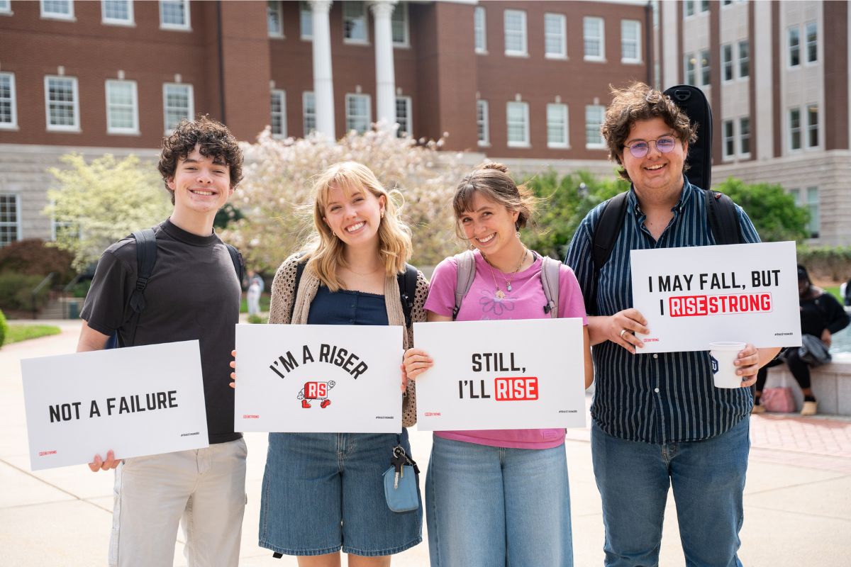 Students holding RiseStrong students