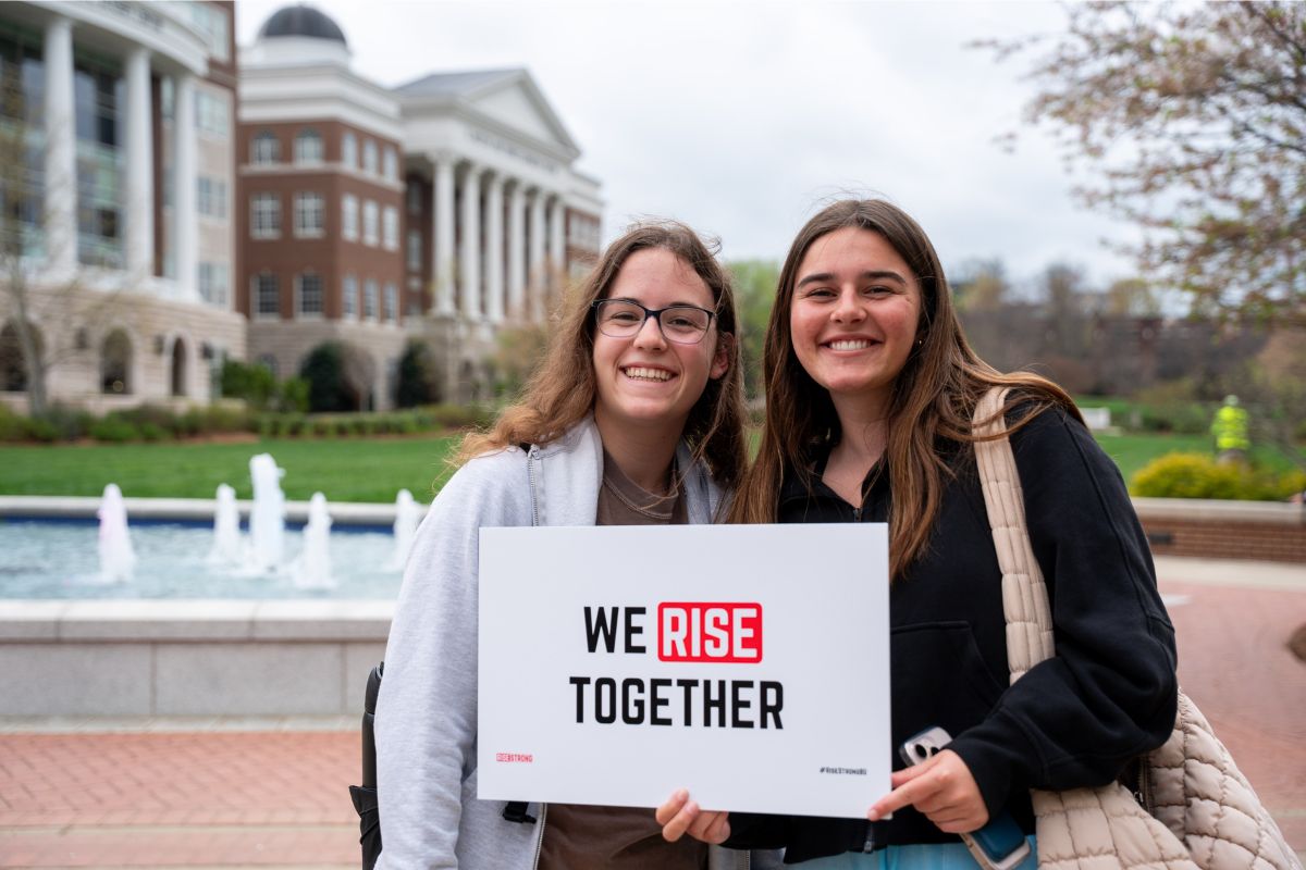Students holding RiseStrong students