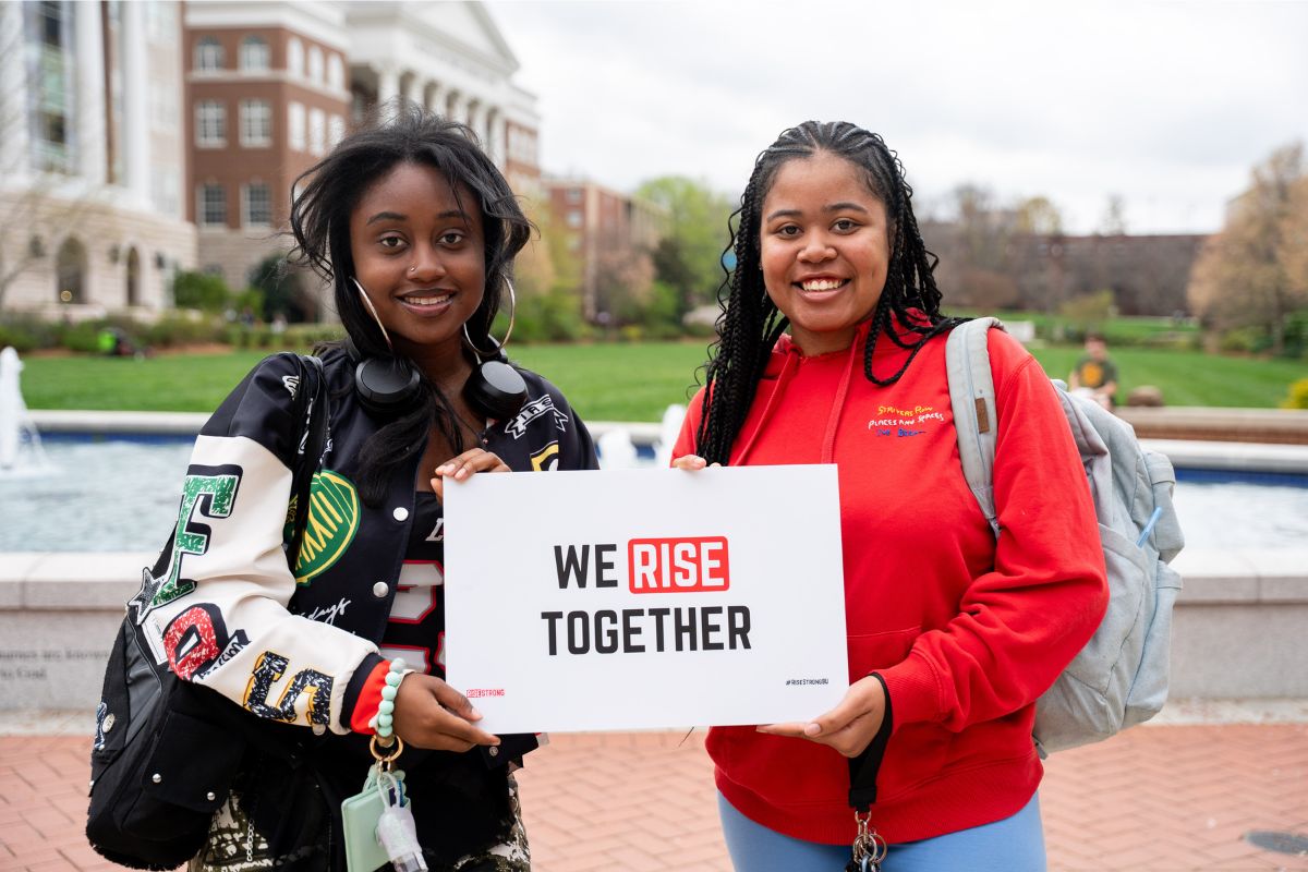 Students holding RiseStrong students
