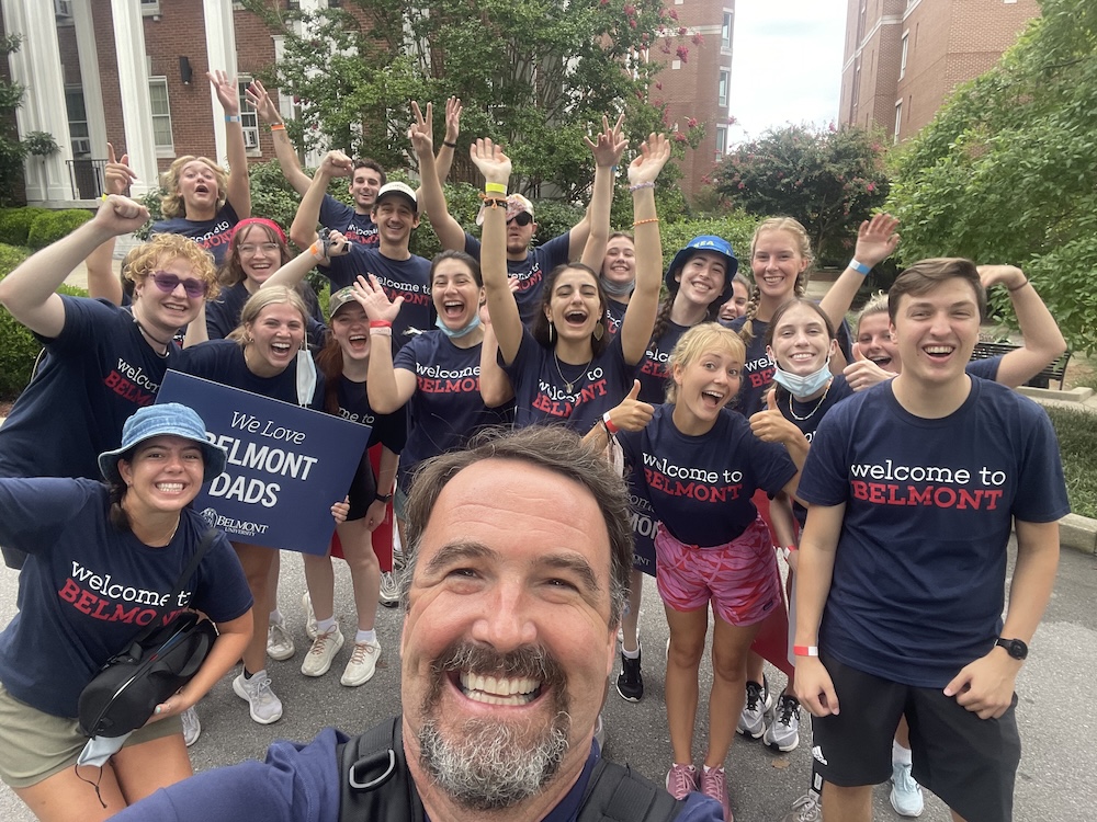 sam takes a selfie with students on move in day