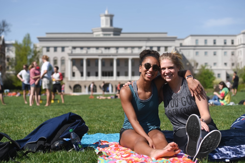 students sitting on the lawn
