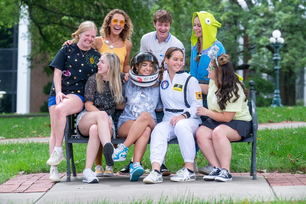 a group of students smile in silly costumes
