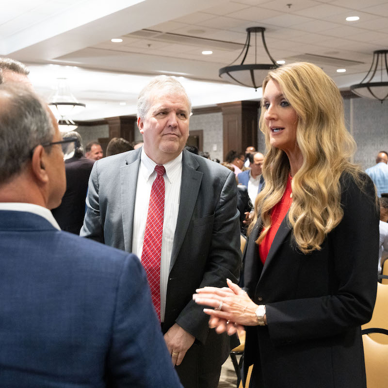 Loeffler and Jones speaking with others
