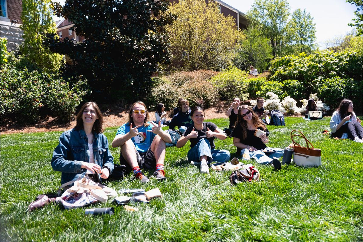 students sit on the lawn