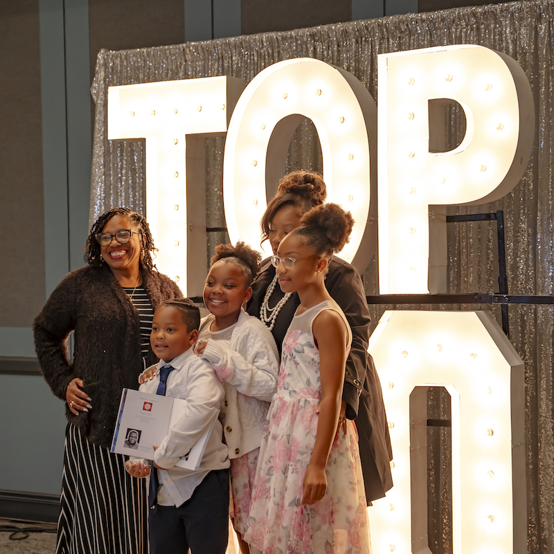 Alumna and family at photo booth