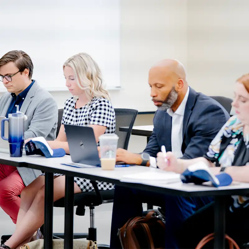 Doctoral students participating in an interactive session in a classroom at Belmont University