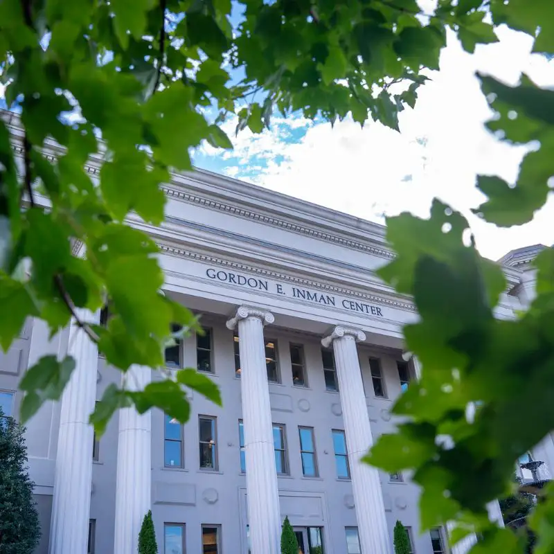 An outdoor view of Inman College of Nursing through the trees