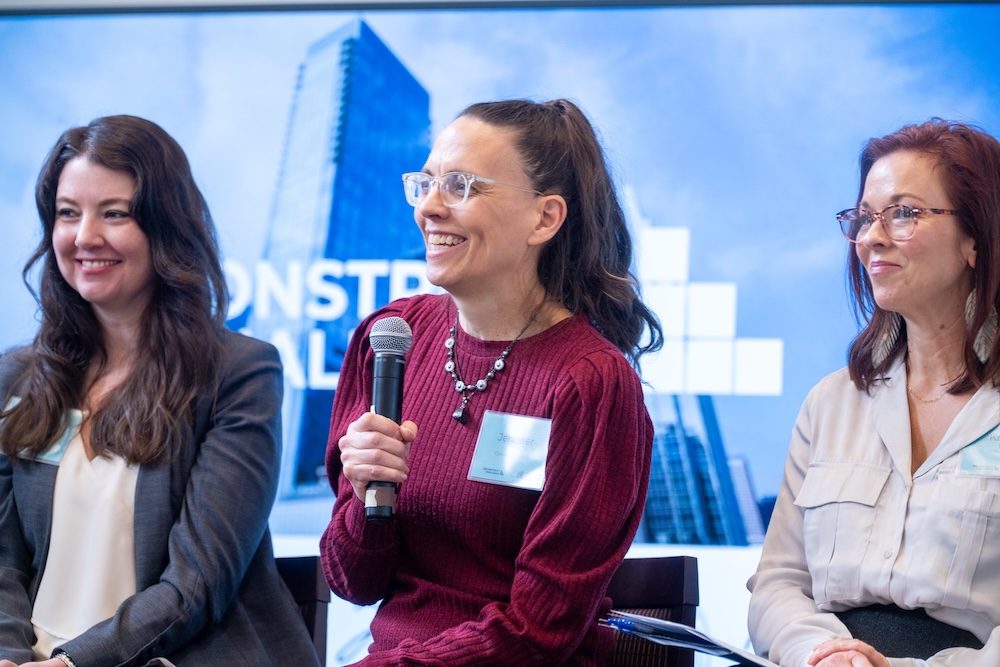 a panel speaker talks into the microphone