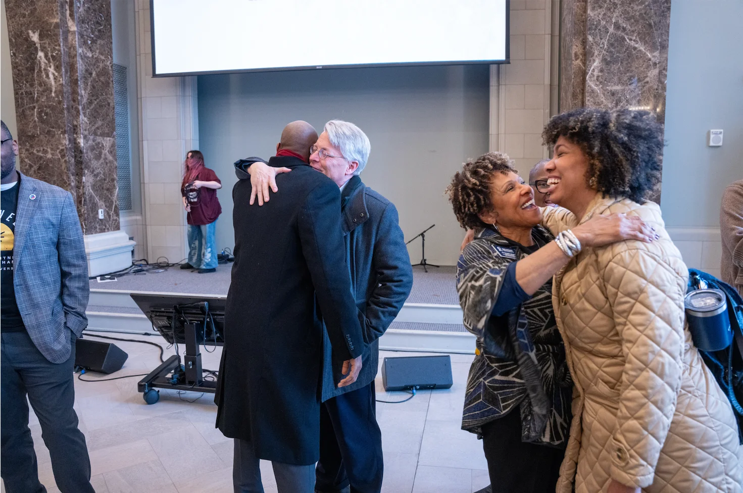 People greeting each other warmly in chapel