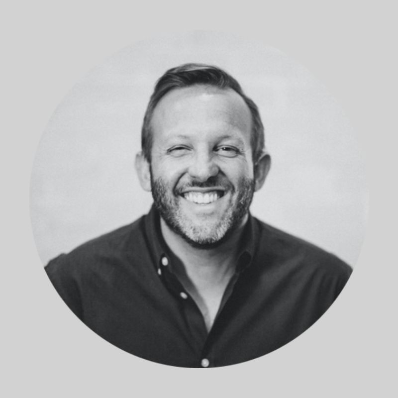 Headshot of Andrew Greer on grey background