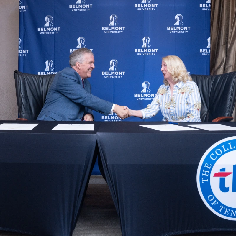 Officials shake hands, finalizing a new partnership agreement.