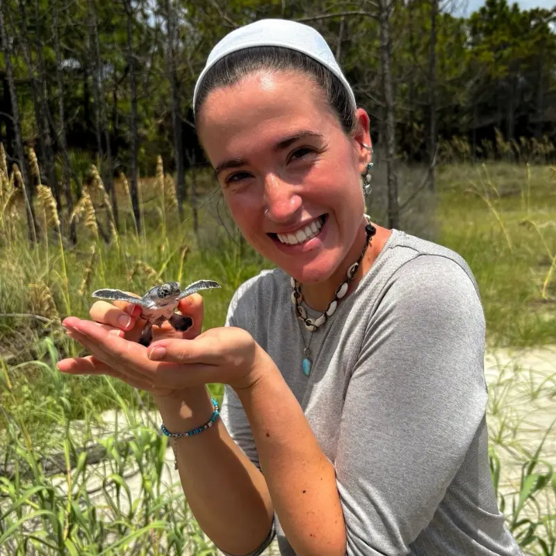 Mackenzie Boylston holding a turtle