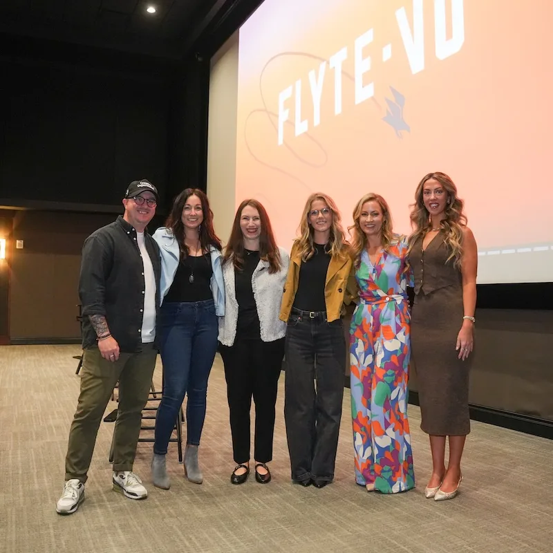 Group of people standing in front of FlyteVu logo.