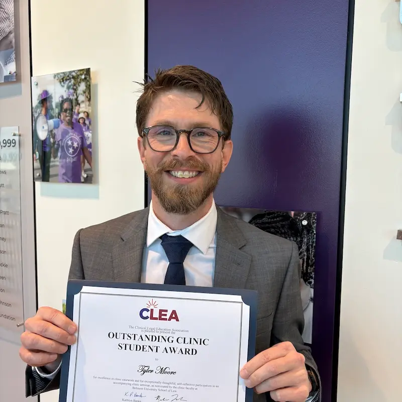 Tyler Moore holding certificate