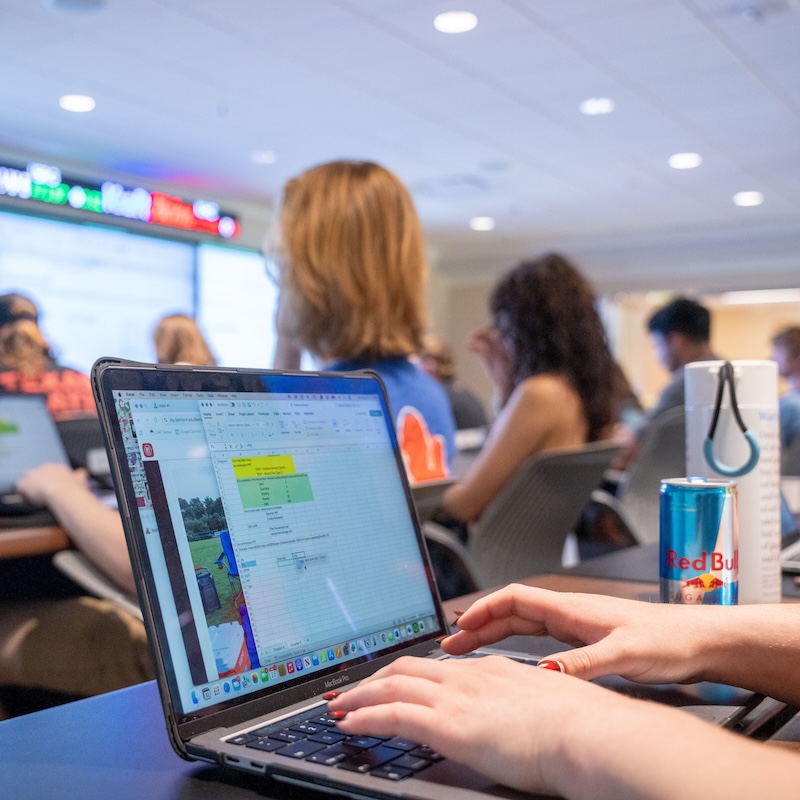 Open laptop with finance class in background
