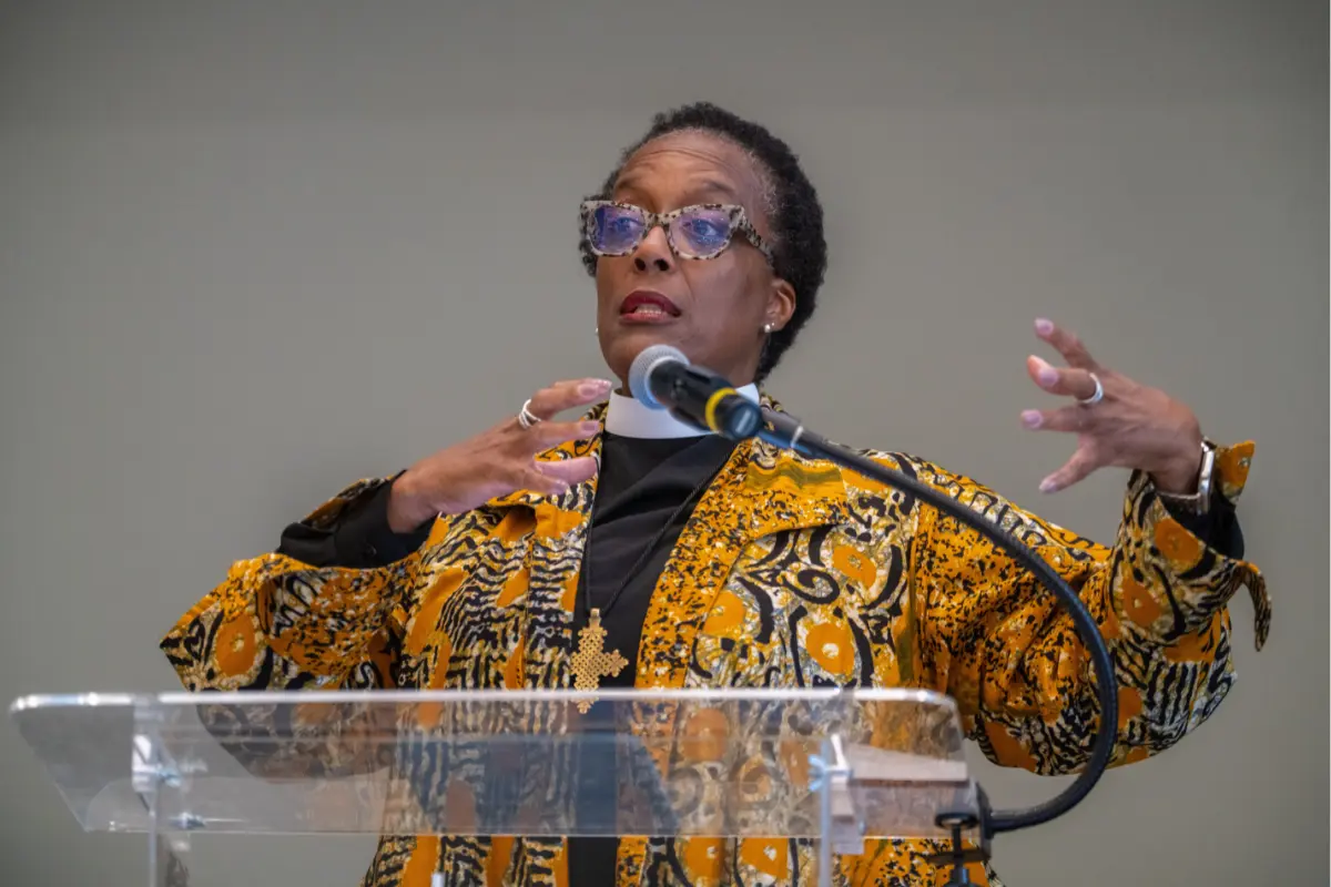 Dr. Lisa Weaver stands at podium delivering a speech 
