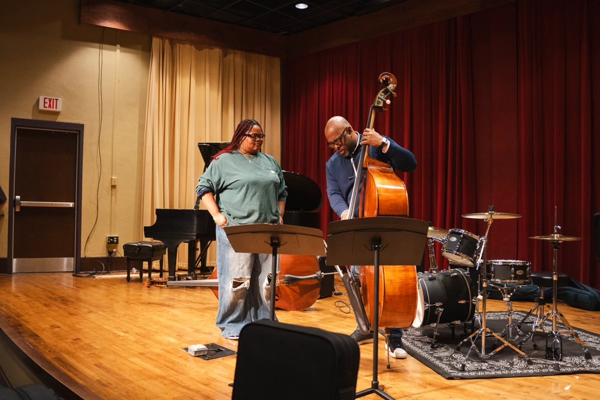 McBride demonstrates something on bass