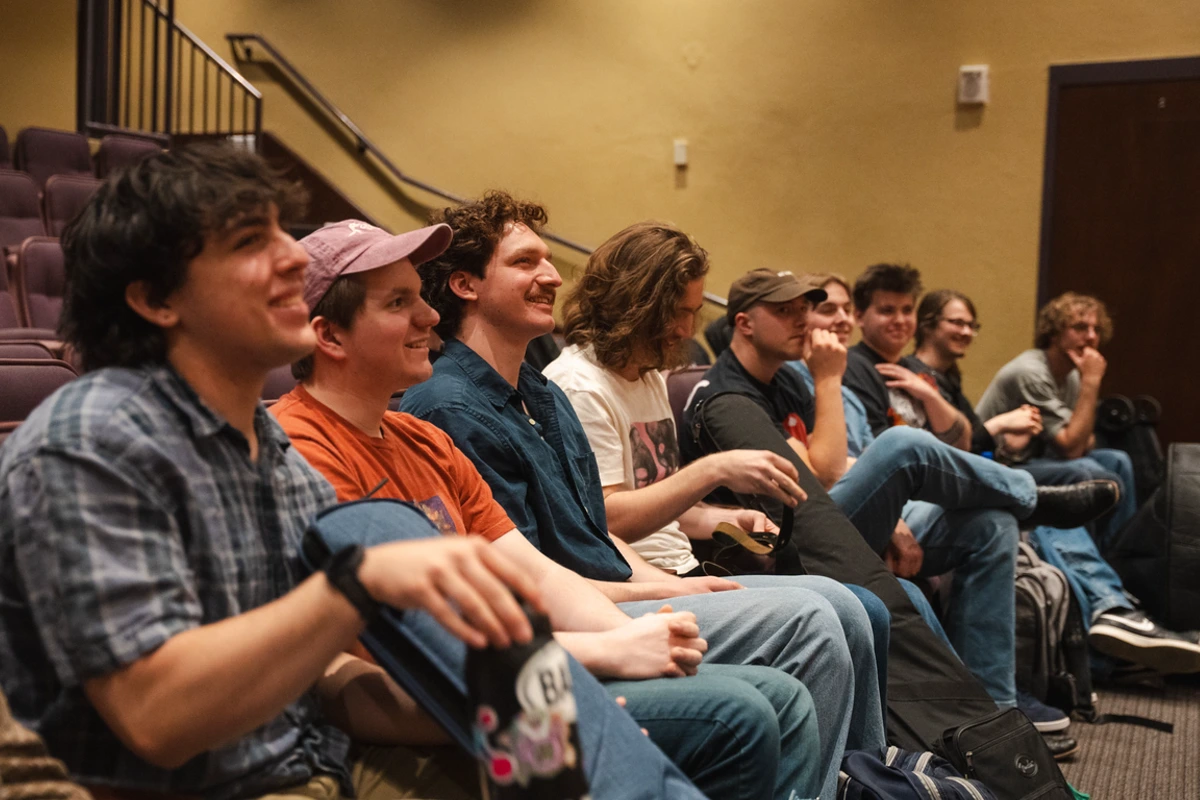 guitar students watch and smile