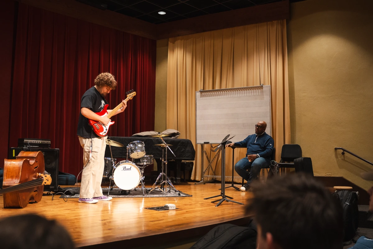 McBride watches student play guitar