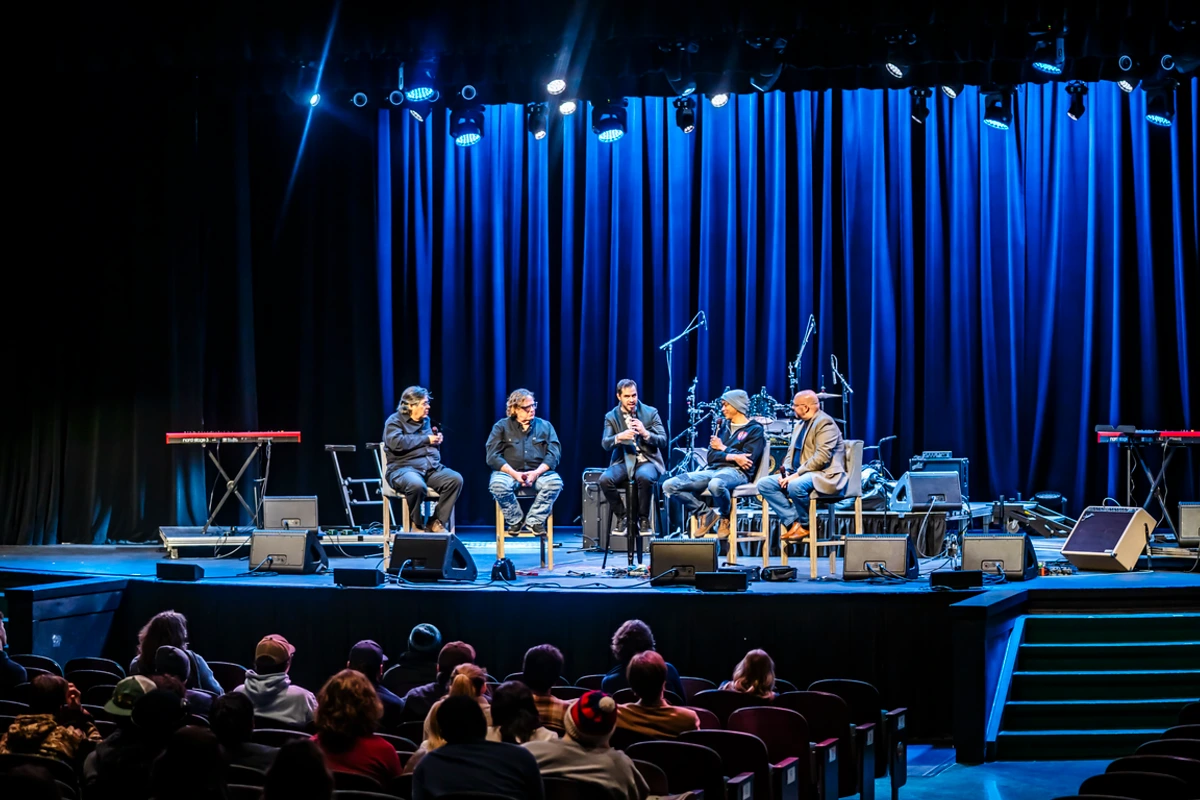 group of people speaking on stage
