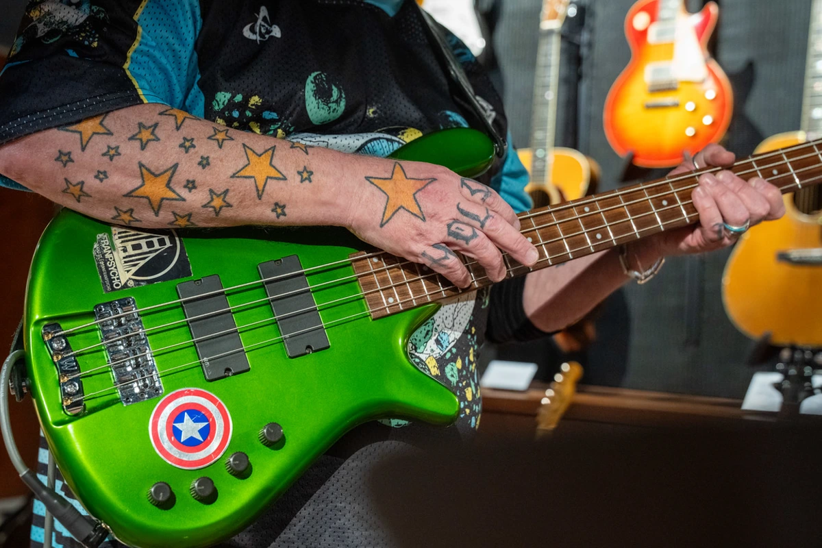 close up of Hamm's arm and guitar