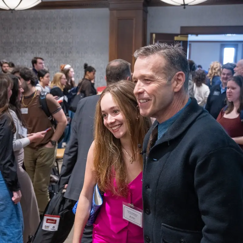 Don Miller takes picture with student