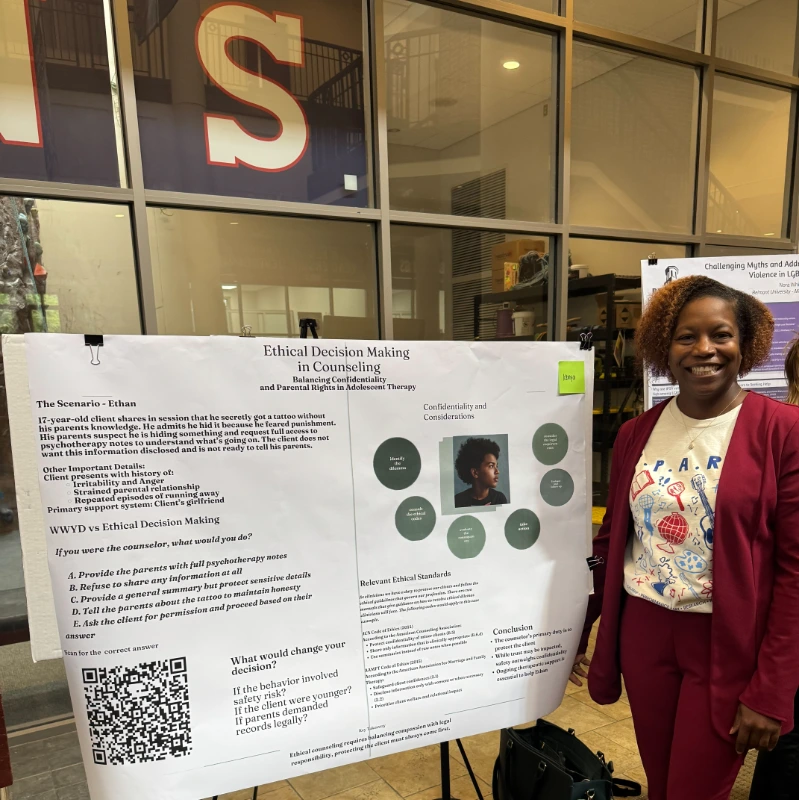 A student smiling with her research poster