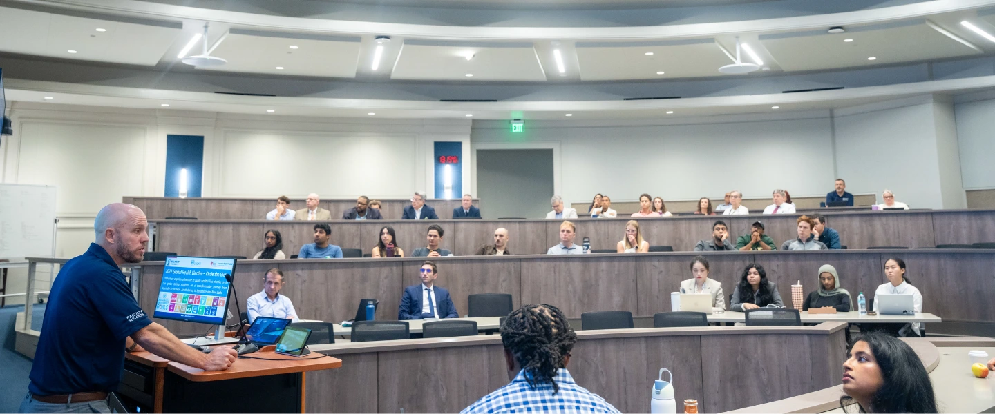 Dr. Ben Ryan speaks to a room of medical students, faculty and mentors about global research.