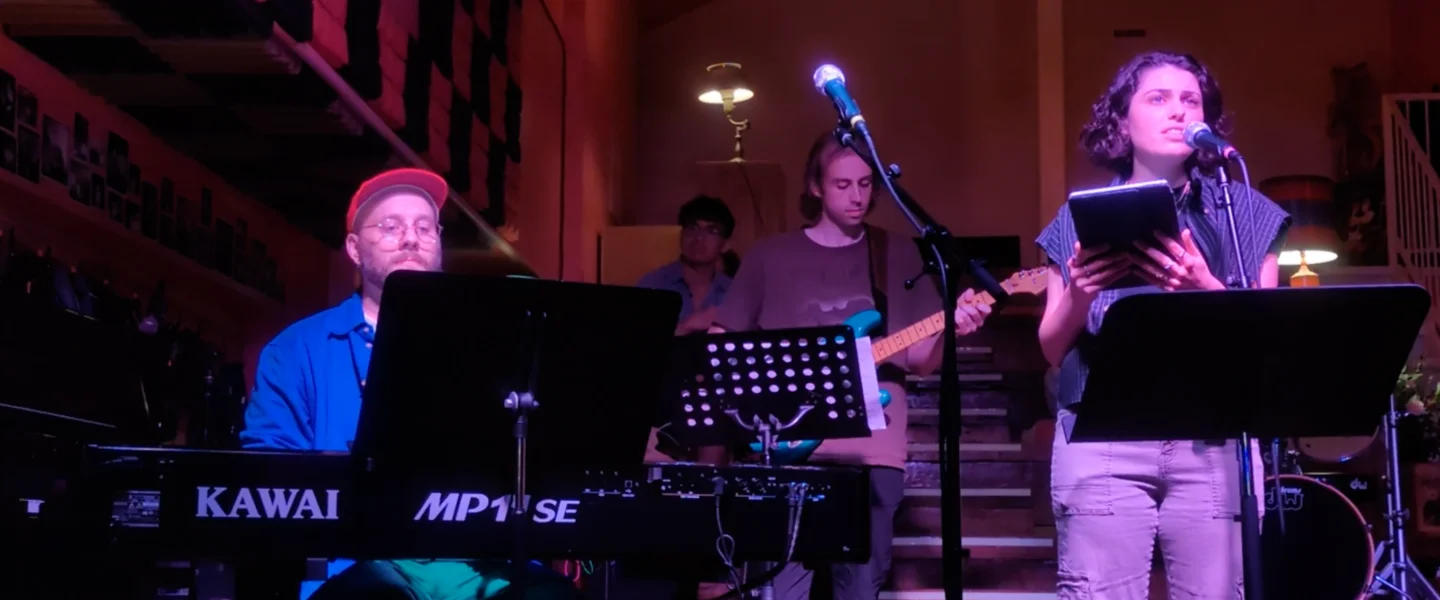 Tim Rosko playing keyboard on stage with a band