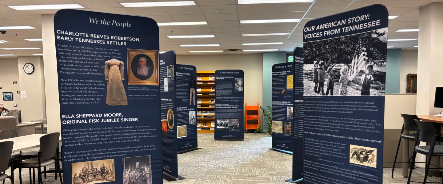 Historical exhibit with blue panels, 'We the People' and 'Our American Story: Voices from Tennessee' on display.